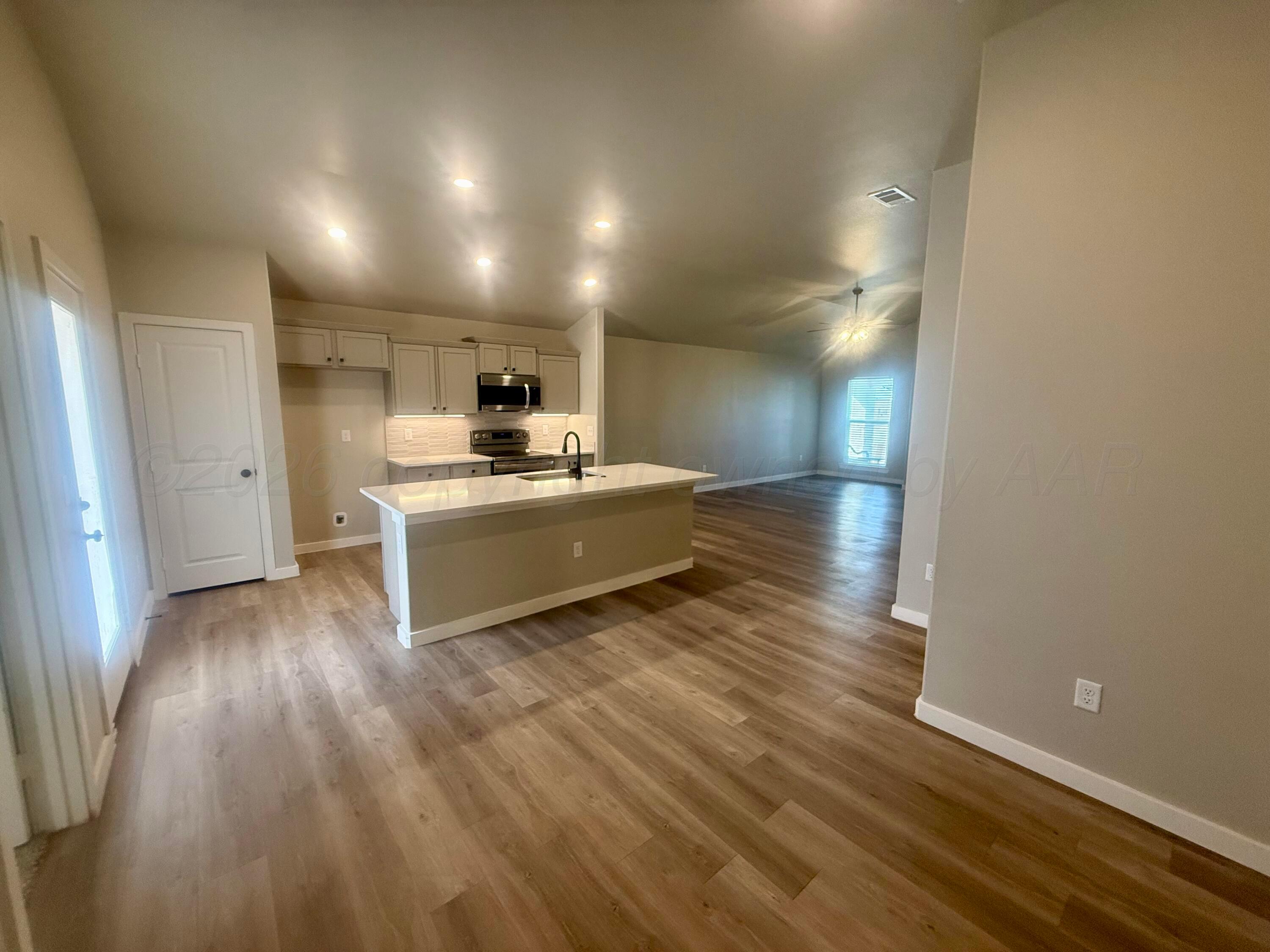 1529 Lullwater Road Amarillo, TX 79118 - Photo 17 of 29 a view of a kitchen counter space and wooden floor