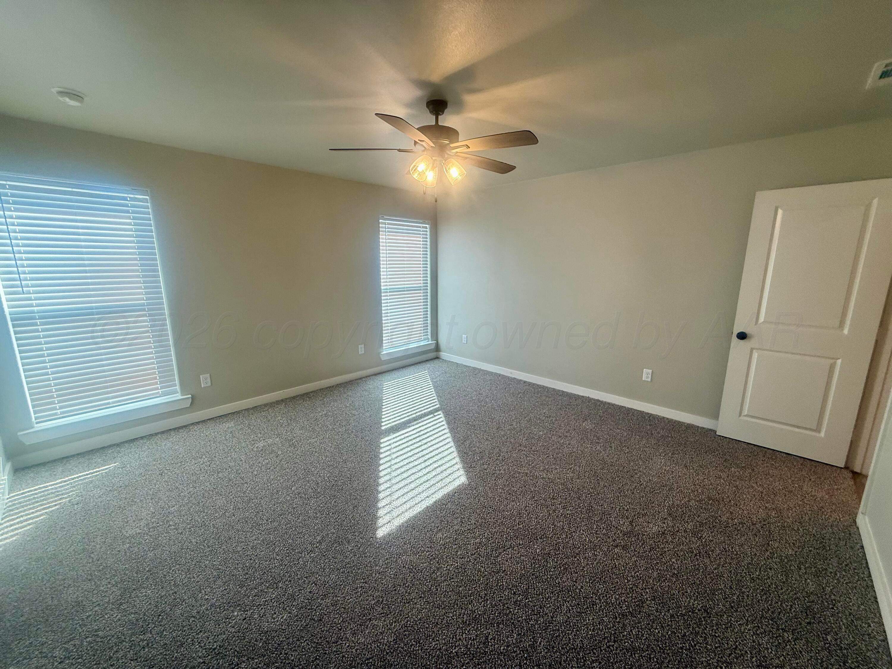 1529 Lullwater Road Amarillo, TX 79118 - Photo 19 of 29 en empty room with windows and fan