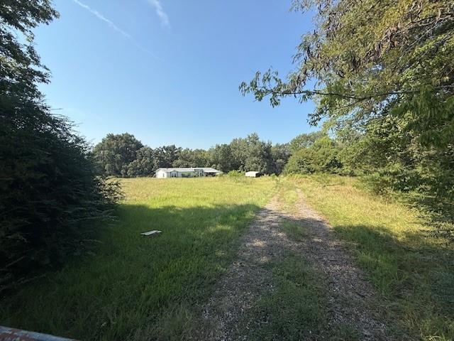 12980 Fm 44 South Avery, TX 75554 - Photo 2 of 2 a view of a lake with a big yard