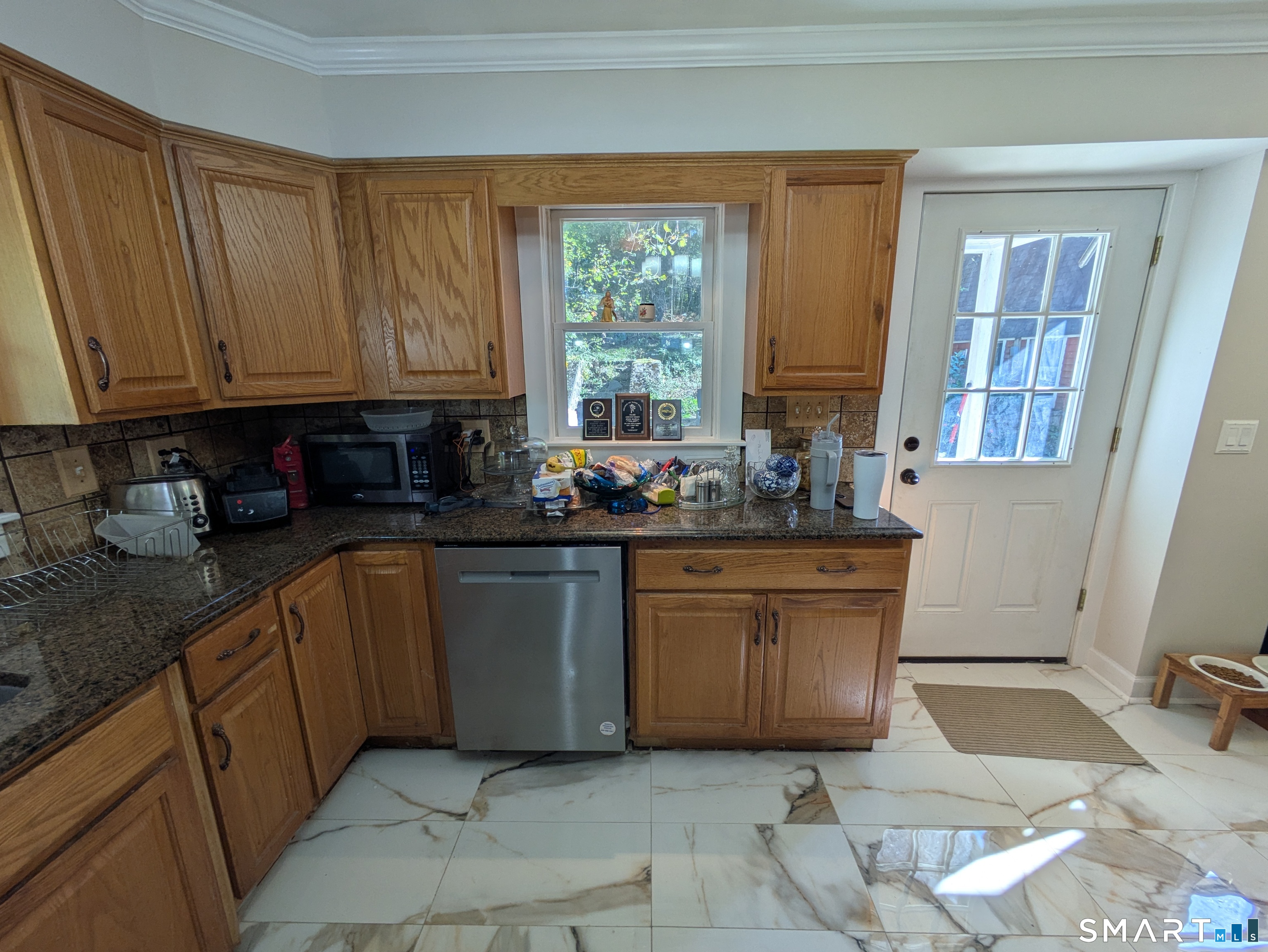 541 Benson Road Middlebury, CT 06762 - Photo 18 of 20 a kitchen with sink a window and cabinets
