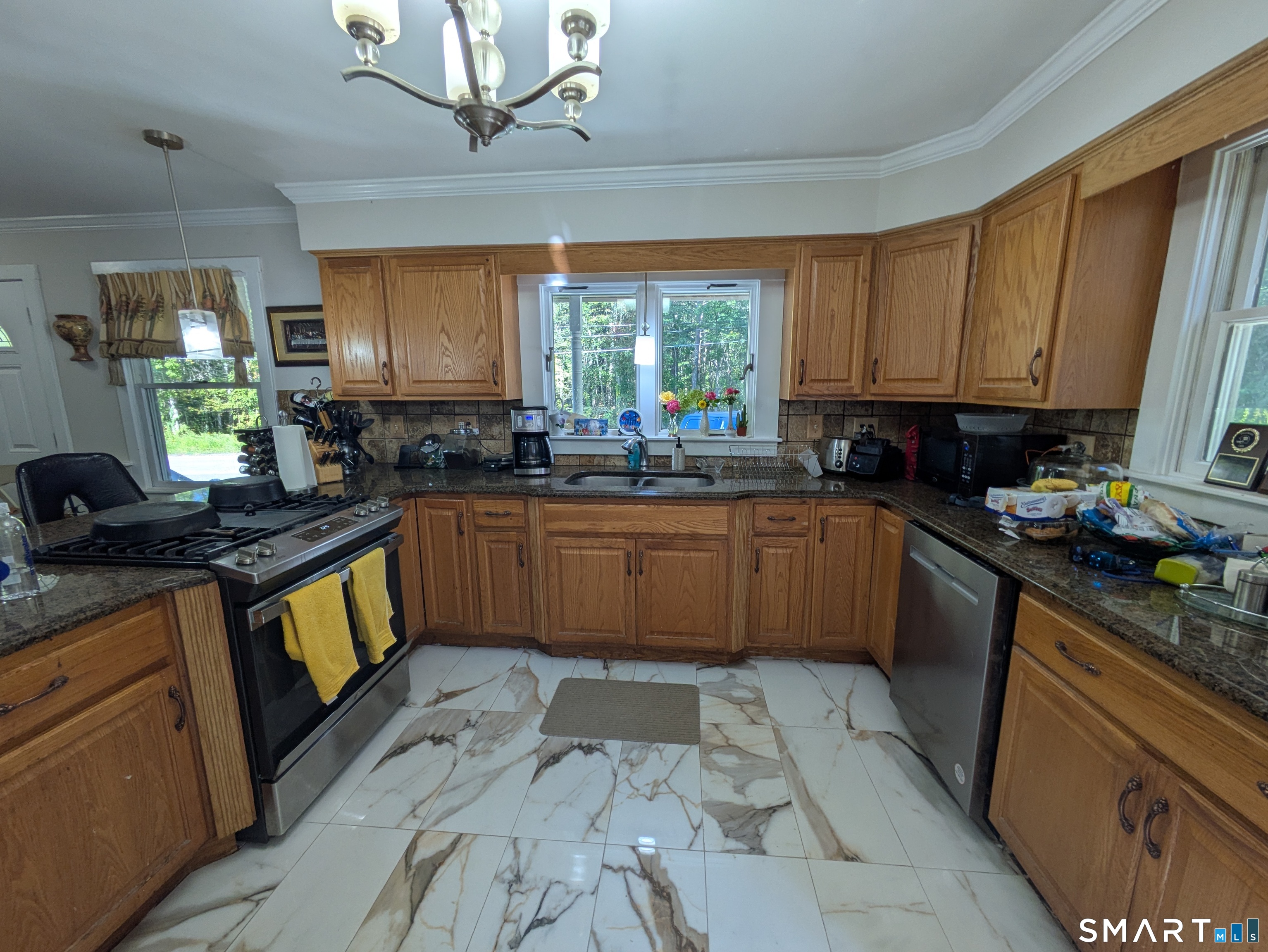 541 Benson Road Middlebury, CT 06762 - Photo 19 of 20 a kitchen with stainless steel appliances granite countertop a sink a stove top oven a counter space and cabinets