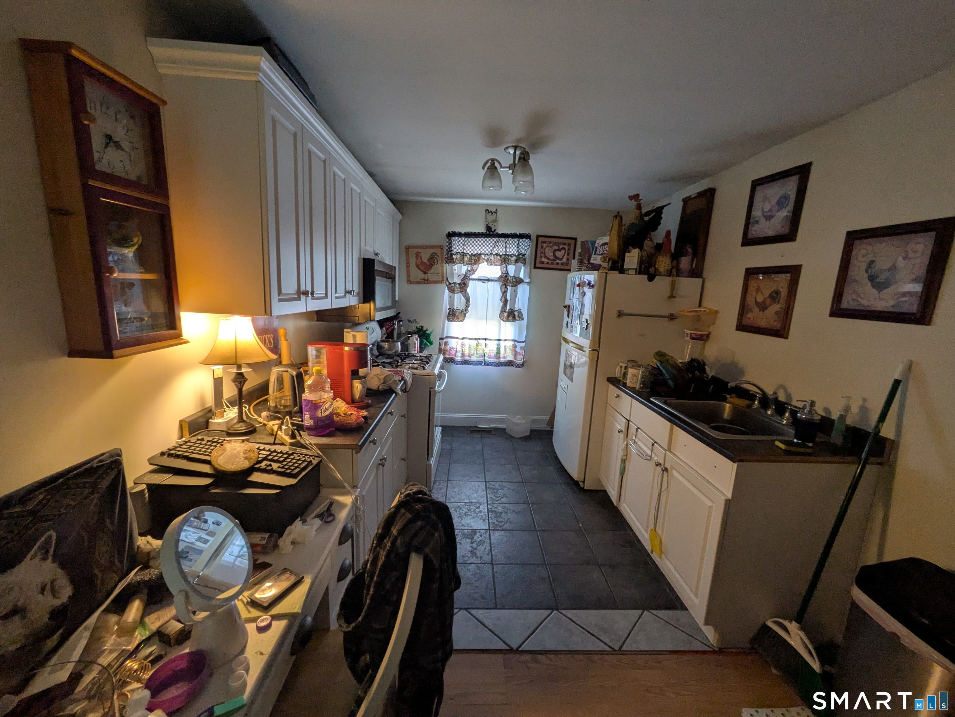 541 Benson Road Middlebury, CT 06762 - Photo 7 of 20 a kitchen with a refrigerator and a stove top oven