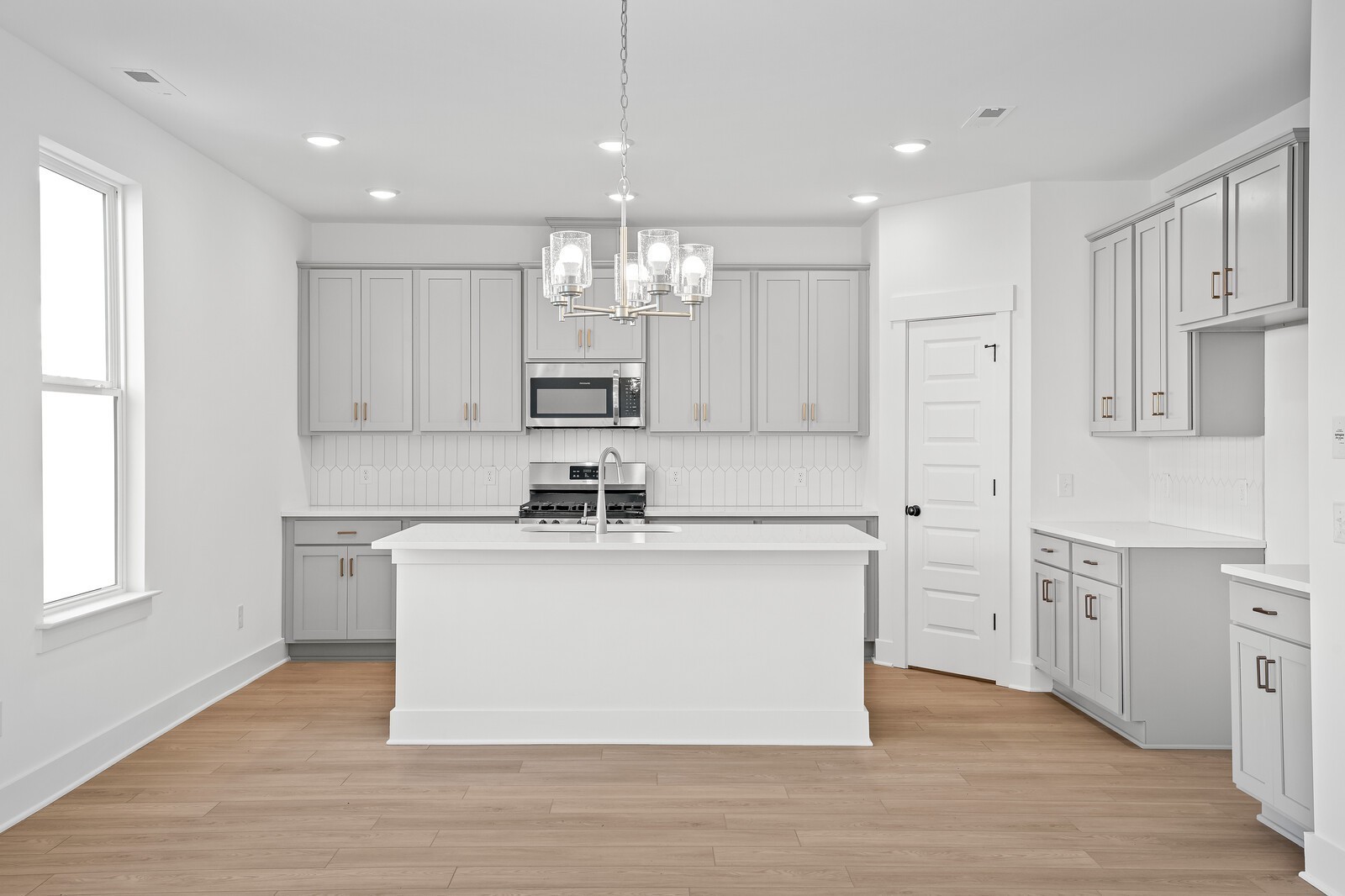 2155 Barnwood Road Gallatin, TN 37066 - Photo 17 of 51 a kitchen with stainless steel appliances granite countertop a white cabinets a sink dishwasher and a stove with wooden floor