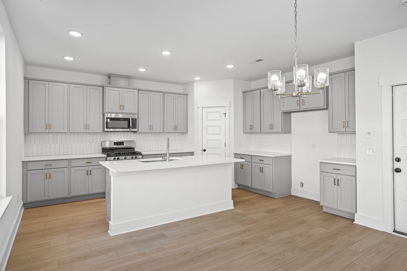 2155 Barnwood Road Gallatin, TN 37066 - Photo 18 of 51 a kitchen with kitchen island granite countertop a sink cabinets and wooden floor