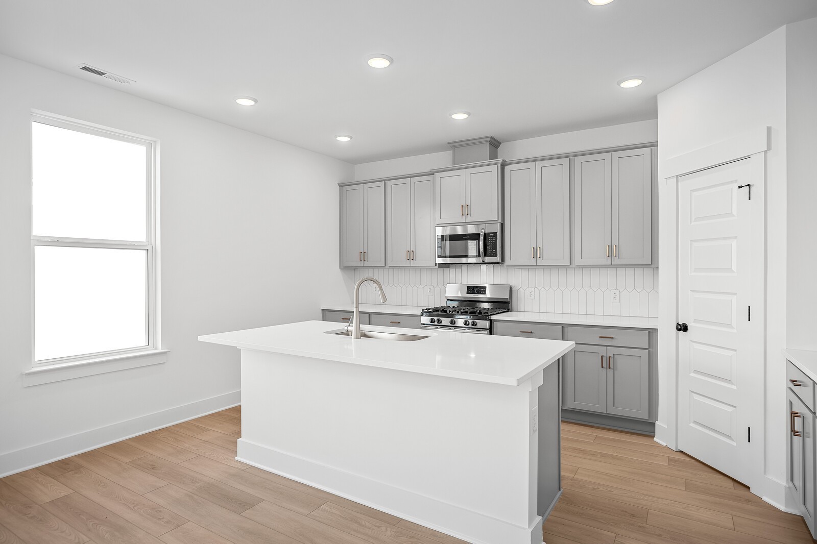 2155 Barnwood Road Gallatin, TN 37066 - Photo 19 of 51 a kitchen with kitchen island white cabinets and white appliances