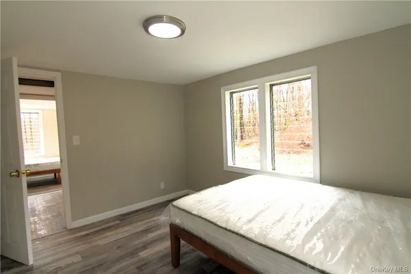 a view of a room with wooden floor and windows