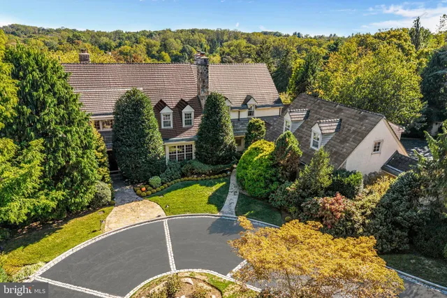 an aerial view of a house with a yard and garden