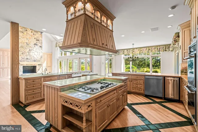 a spacious en suite bathroom with a granite countertop tub and a sink