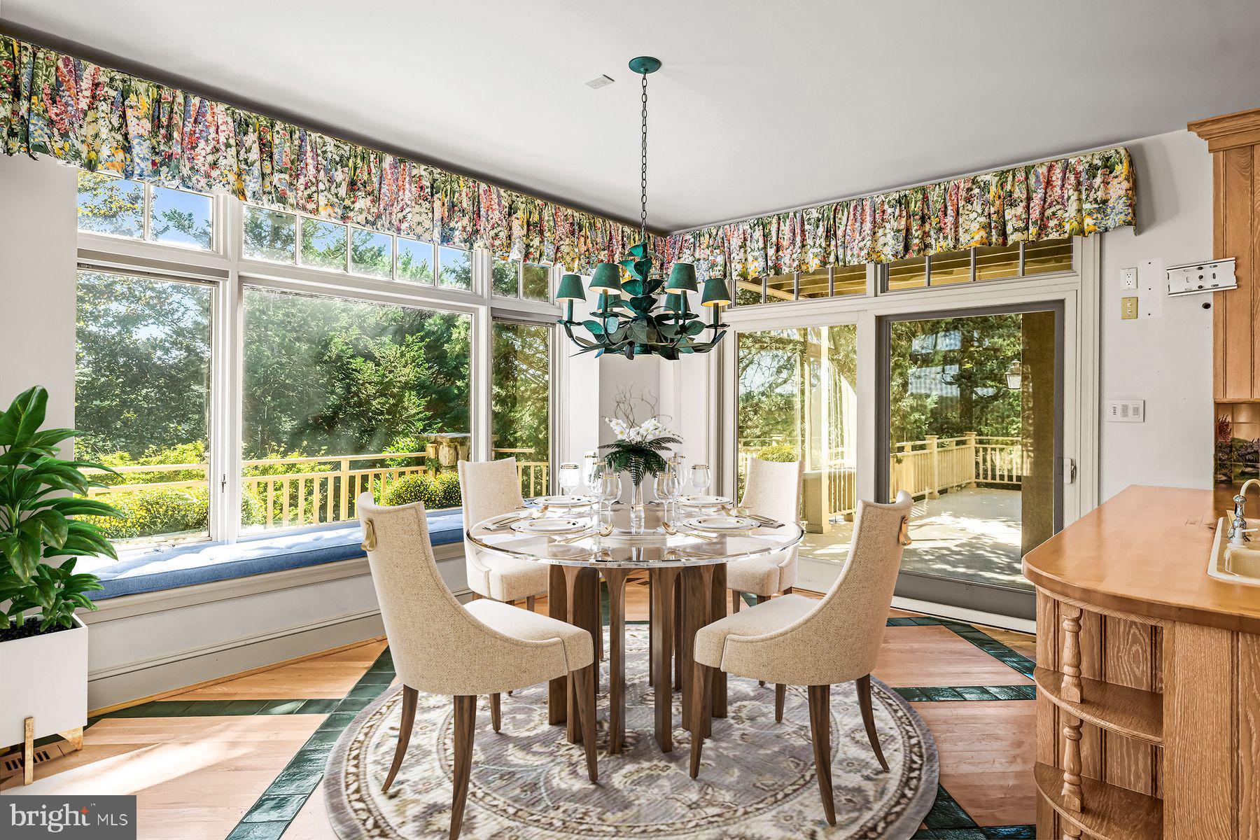 1225 Country Club Road Gladwyne, PA 19035 - Photo 26 of 89 a view of a dining room with furniture large windows and wooden floor