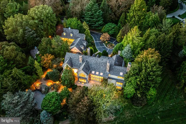 an aerial view of a house with yard swimming pool and outdoor seating