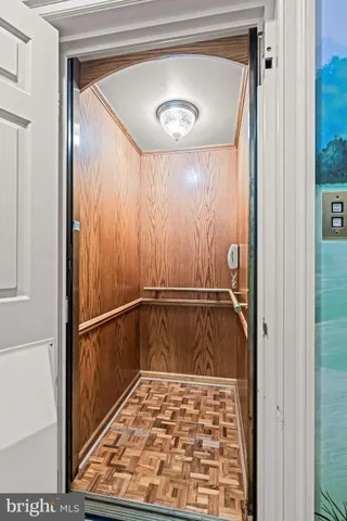 a view of room with wooden floor and large window