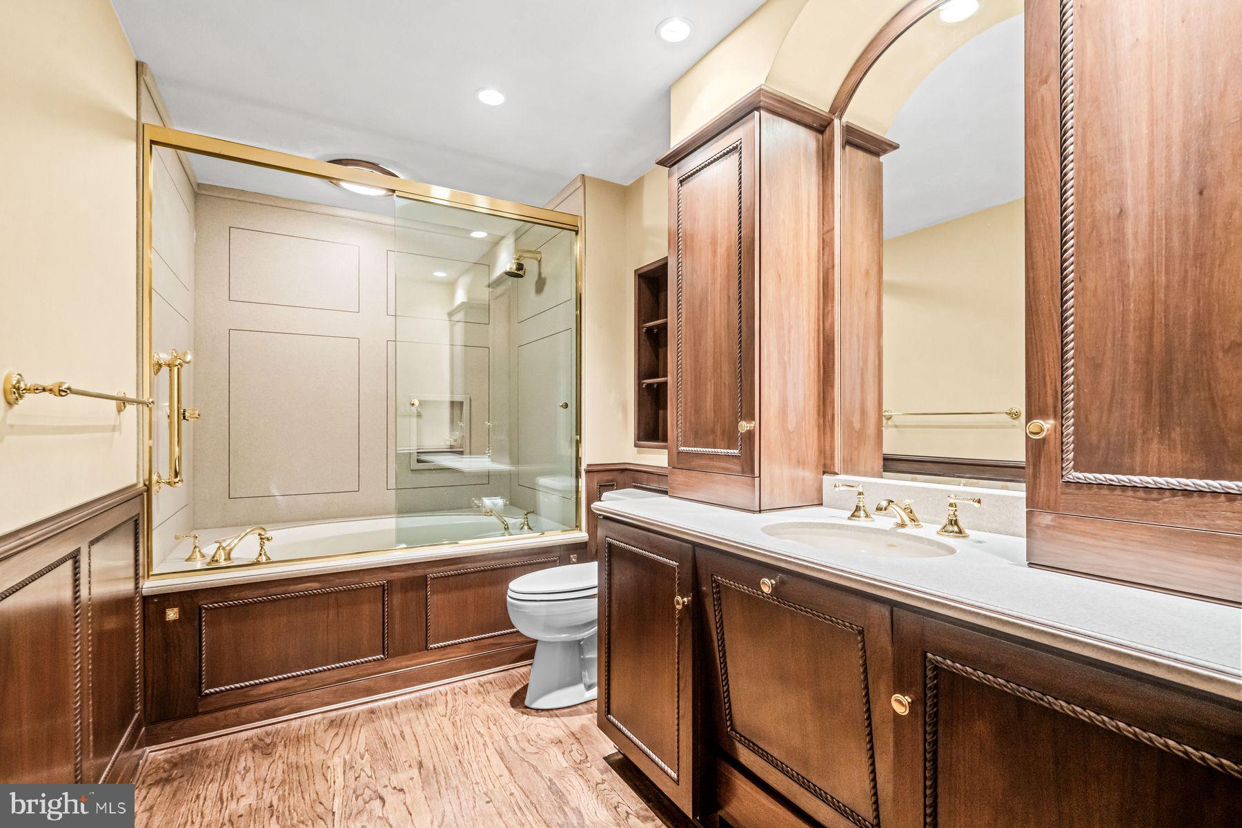 1225 Country Club Road Gladwyne, PA 19035 - Photo 55 of 89 a bathroom with a double vanity sink a large mirror and a bathtub