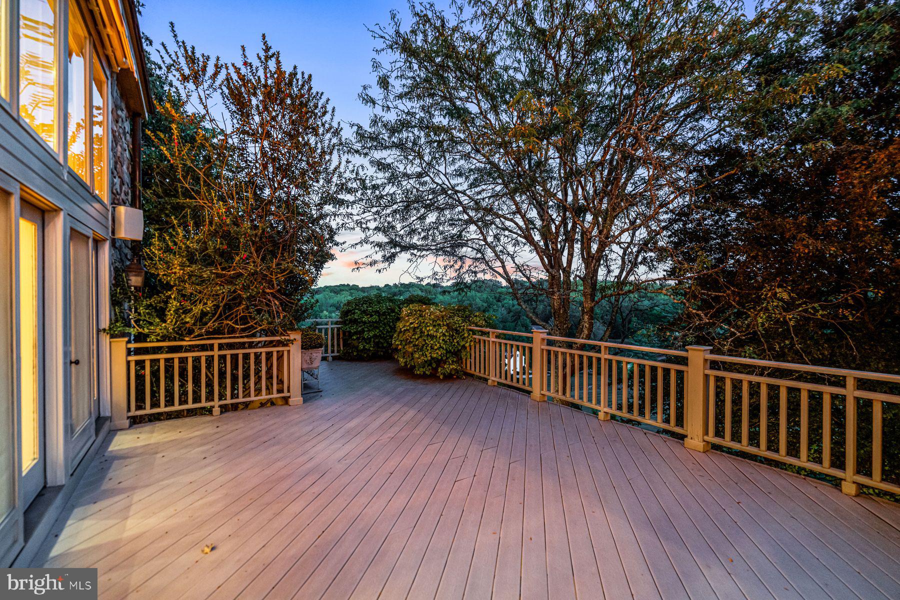 1225 Country Club Road Gladwyne, PA 19035 - Photo 7 of 89 a view of a deck with a table and chairs next to a yard