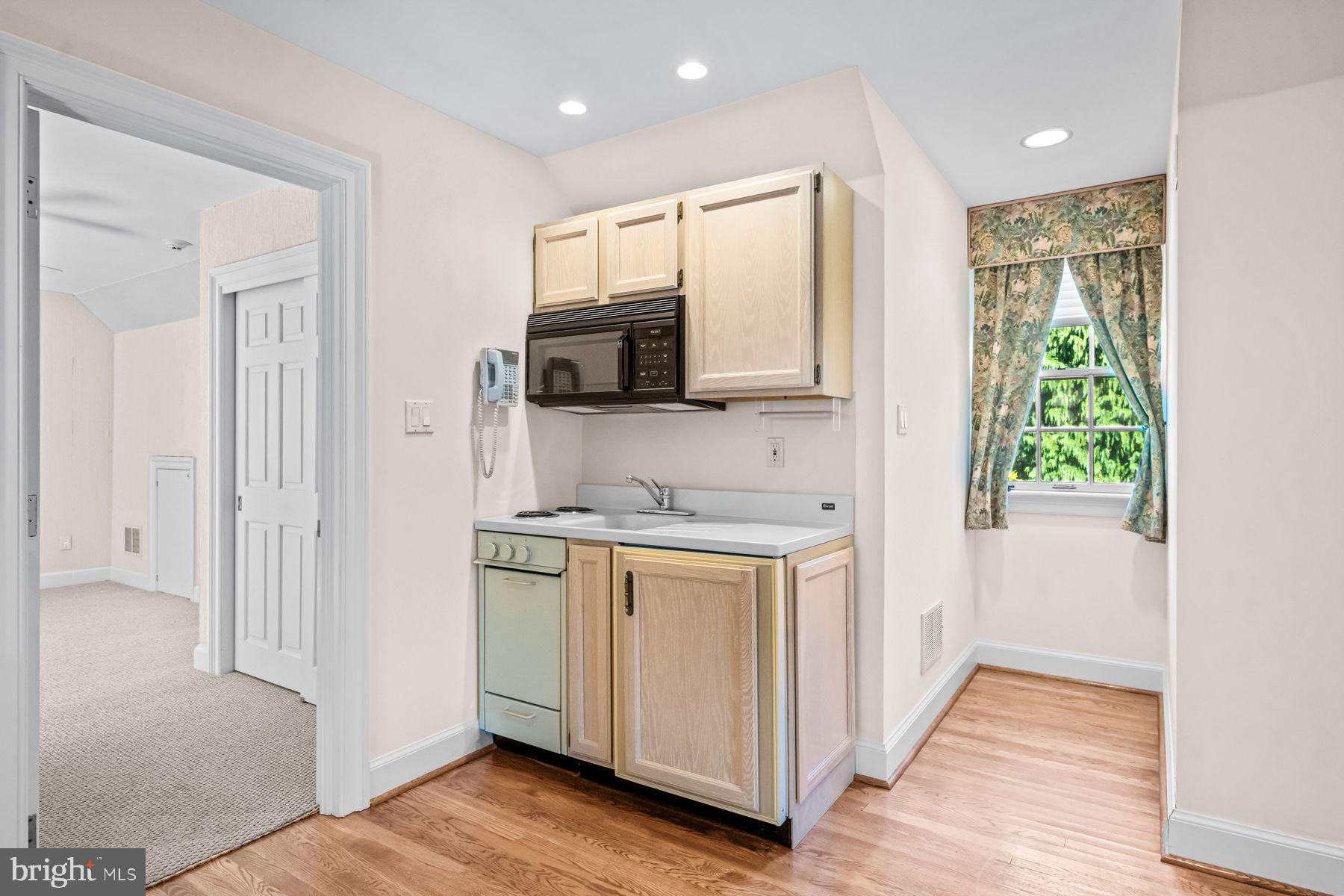 1225 Country Club Road Gladwyne, PA 19035 - Photo 78 of 89 a kitchen with stainless steel appliances granite countertop a stove a sink and a refrigerator with wooden floor