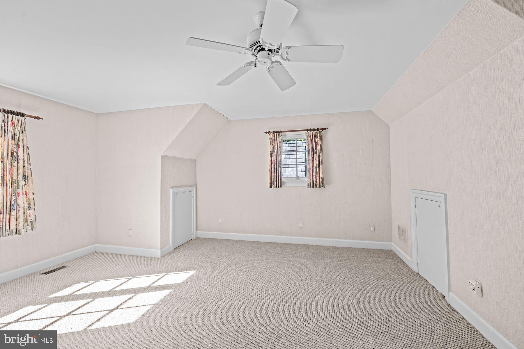 1225 Country Club Road Gladwyne, PA 19035 - Photo 79 of 89 an empty room with windows and fan