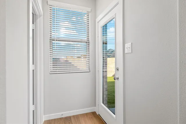 a view of an entryway with wooden floor