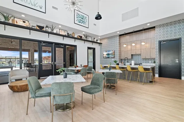 a large kitchen with a table and chairs
