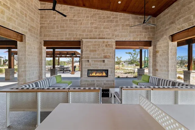 a living room with fireplace furniture and a potted plant