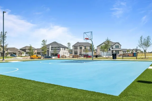 a view of swimming pool with lawn chairs and small yard