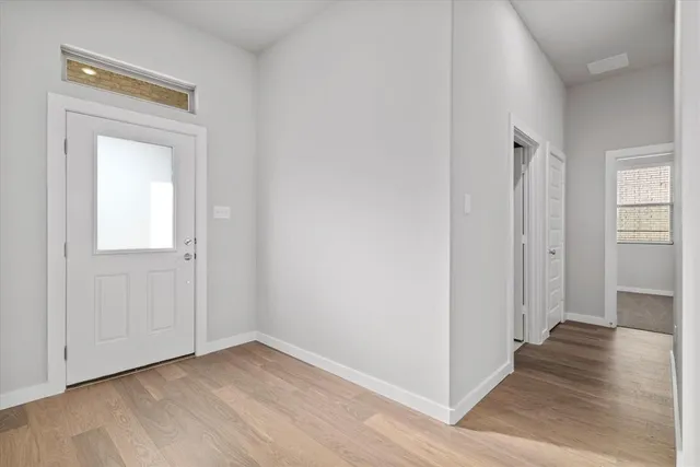 an empty room with wooden floor and closet