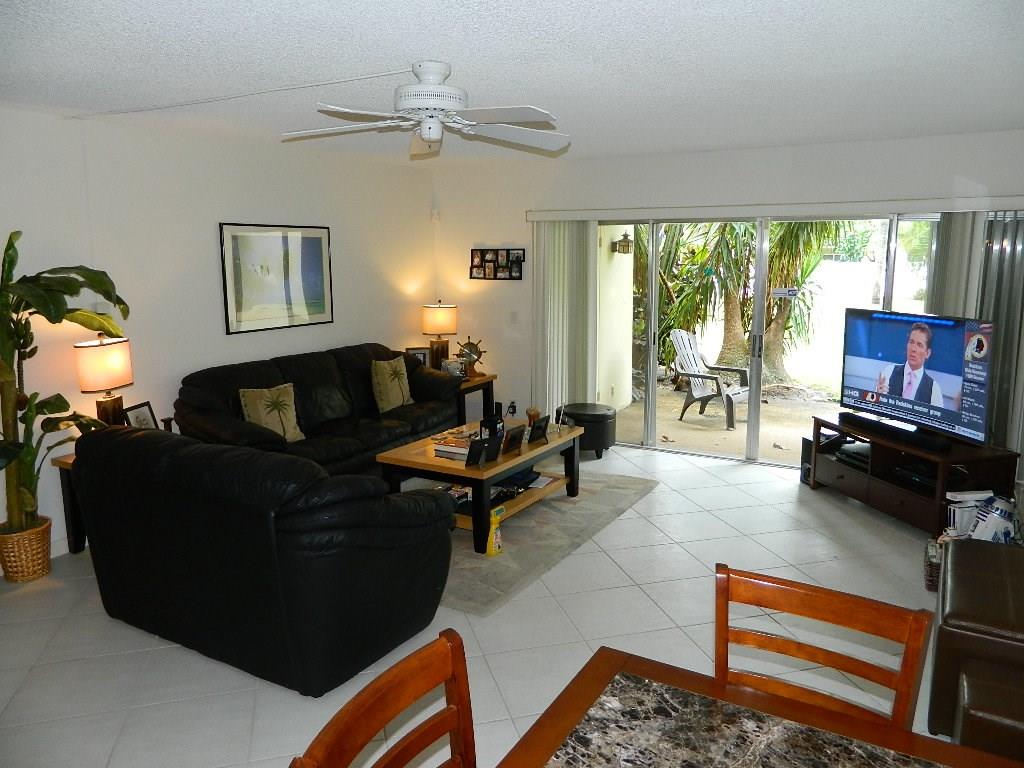 390 Golfview Road, Unit B North Palm Beach, FL 33408 - Photo 5 of 22 a living room with furniture and a flat screen tv