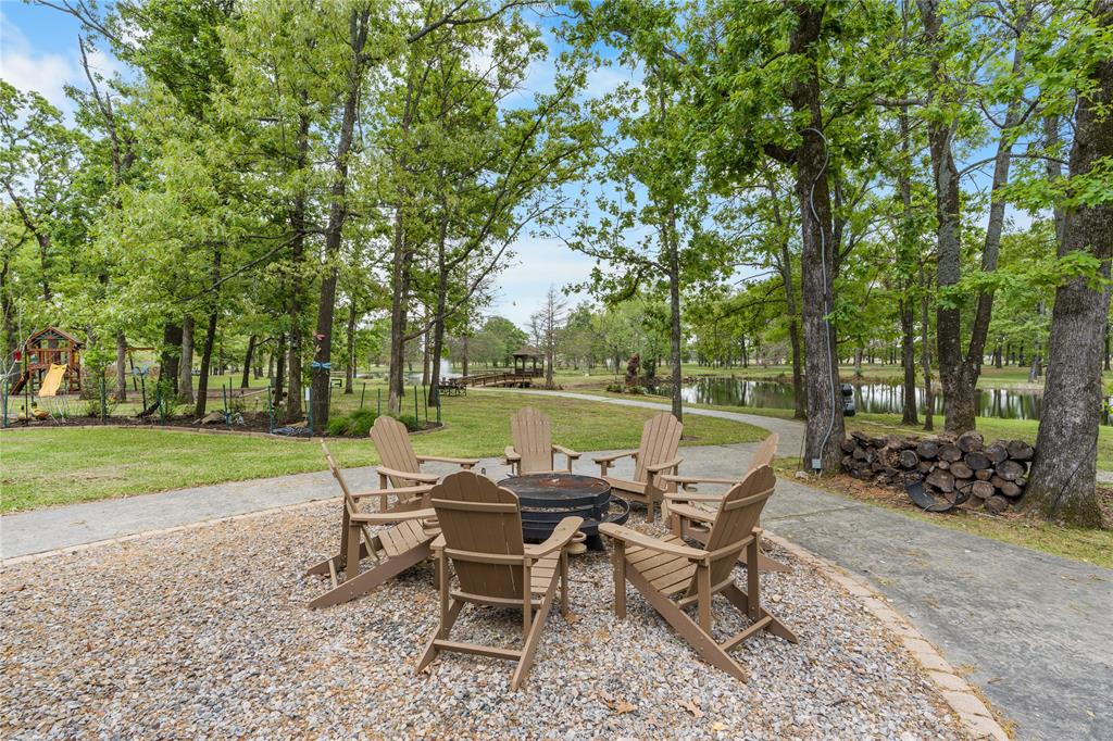 692 Private Road 5937 Emory, TX 75440 - Photo 35 of 40 a view of a wooden bench and trees in the back yard