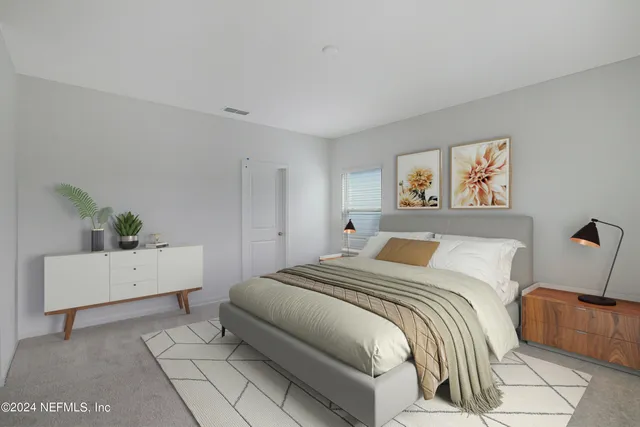 a bedroom with a bed and a potted plant