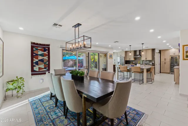 a kitchen with stainless steel appliances kitchen island granite countertop a sink and white cabinets