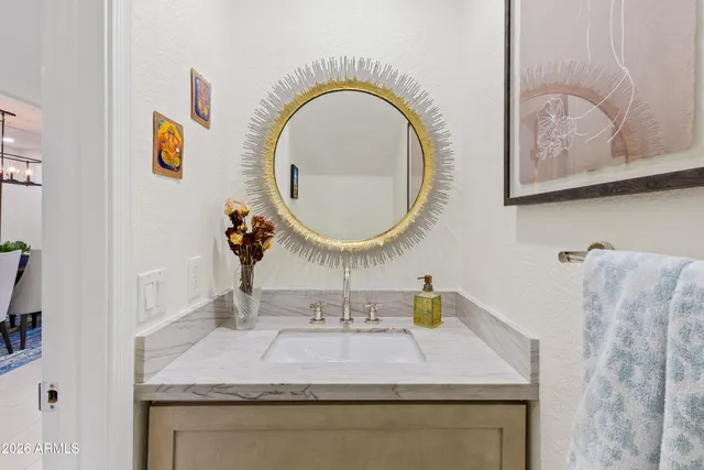 a bathroom with a bathtub shower sink and mirror