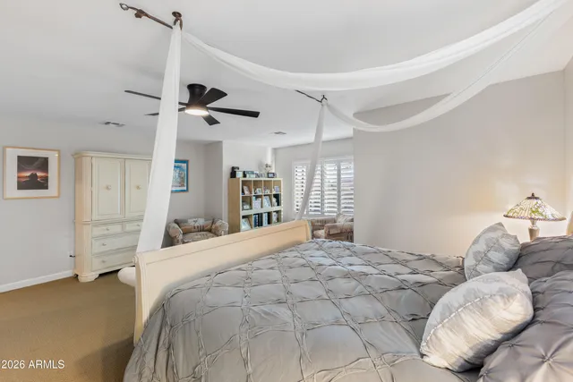 a bedroom with a bed and a desk