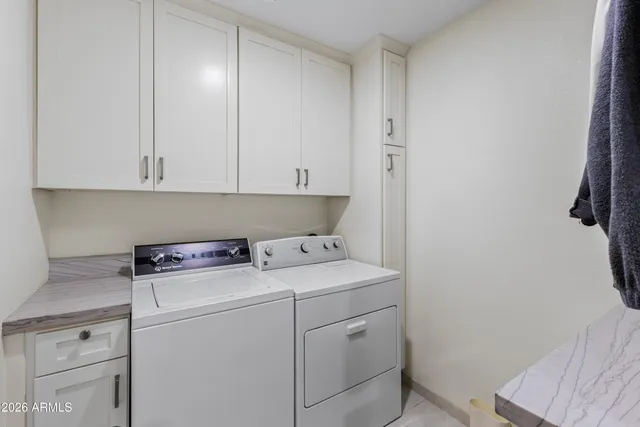 an aerial view of residential houses with outdoor space and ocean view