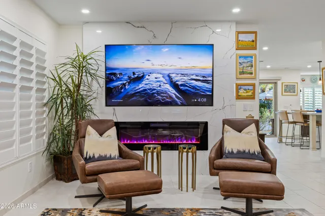 a living room view with a fireplace and outdoor view