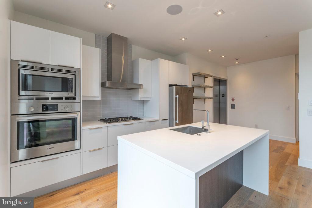 a kitchen with a stove a microwave and a refrigerator