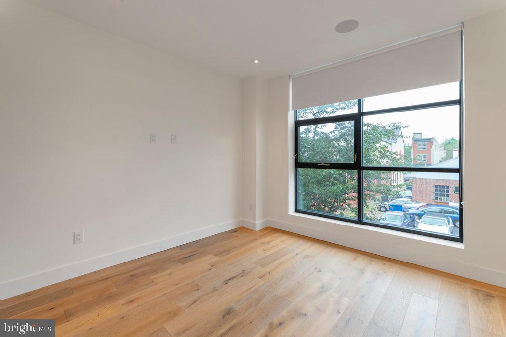 240 North 2nd Street, Unit 2W Philadelphia, PA 19106 - Photo 12 of 13 an empty room with wooden floor and windows