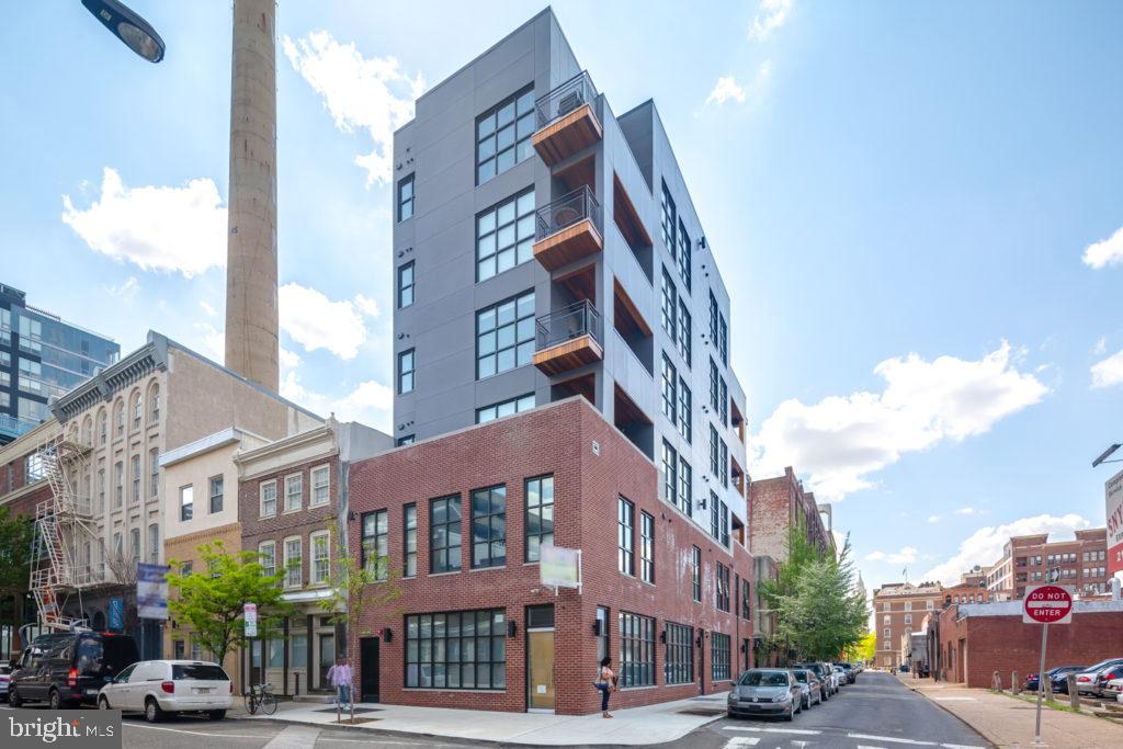 240 North 2nd Street, Unit 2W Philadelphia, PA 19106 - Photo 13 of 13 a front view of a building with lot of cars and trees
