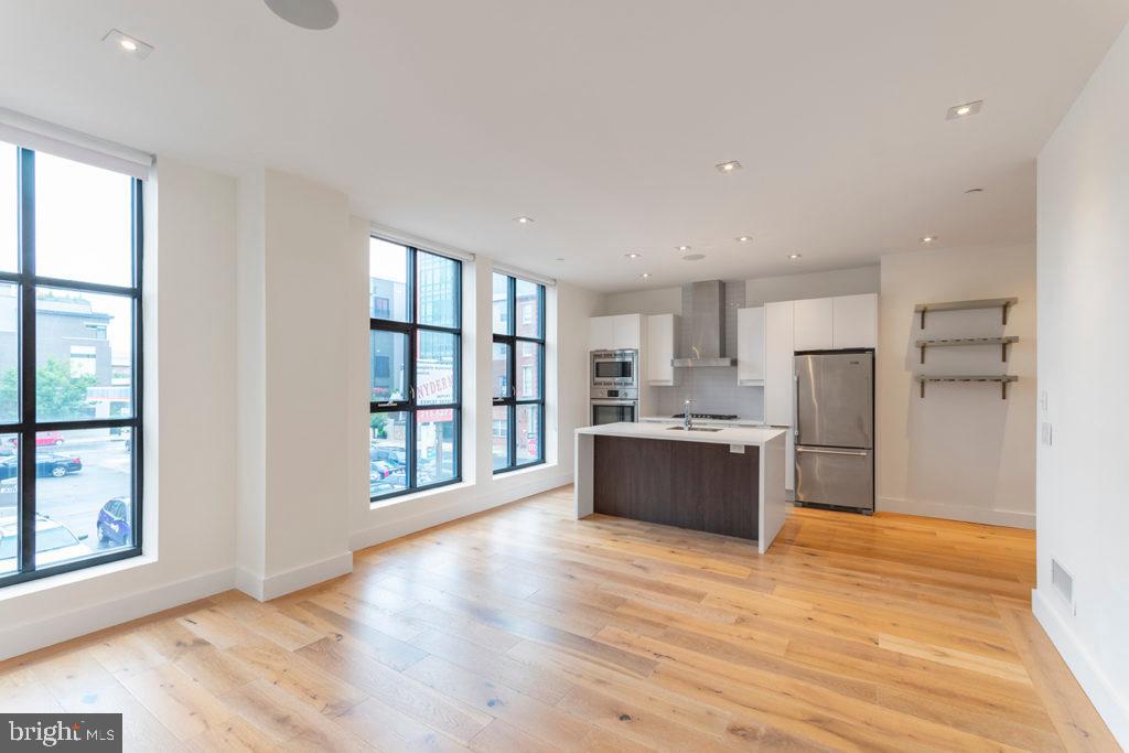 240 North 2nd Street, Unit 2W Philadelphia, PA 19106 - Photo 5 of 13 a large space with a large window and stainless steel appliances