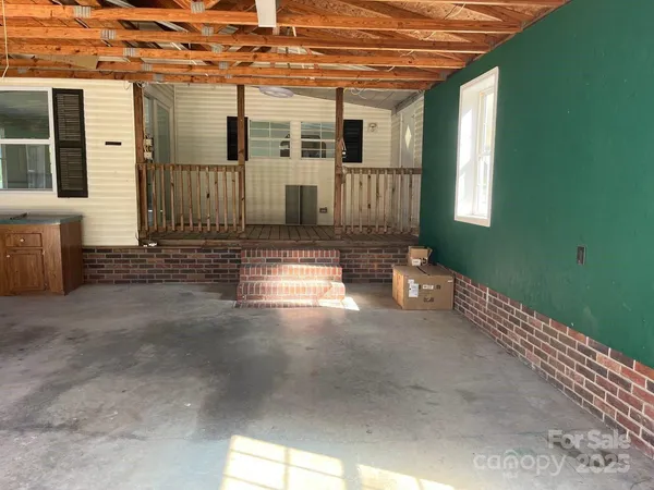 a view of a porch with a table and chairs