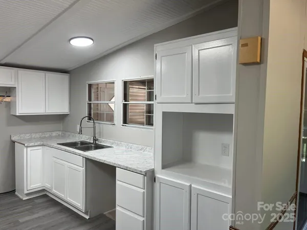 a kitchen with a sink and cabinets