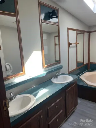 a bathroom with a double vanity sink and a mirror
