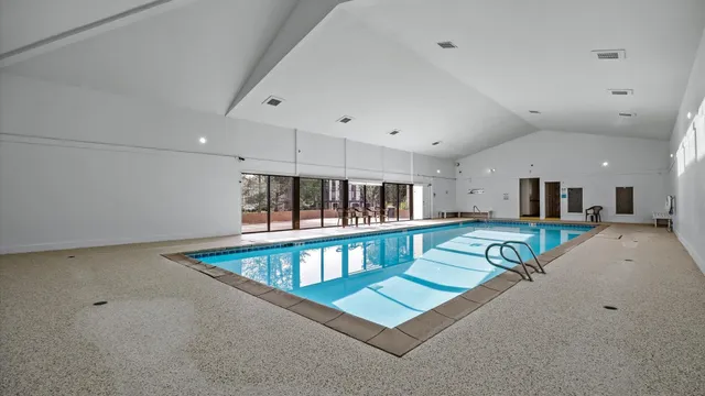 a living room with furniture pool table and chairs