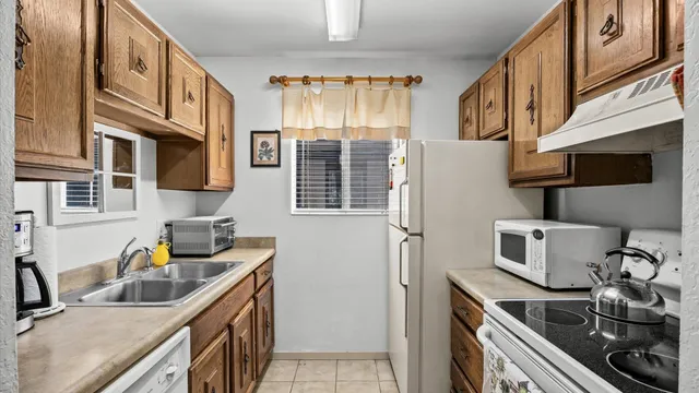 a kitchen that has a sink and a stove
