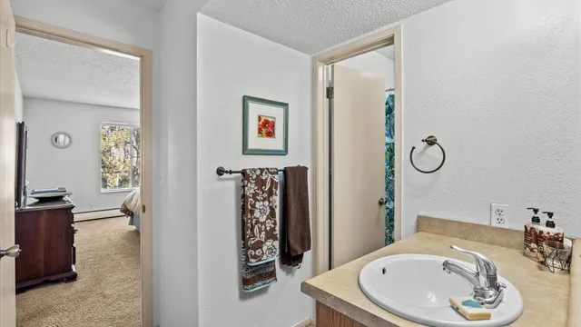 a bathroom with a granite countertop sink and a mirror