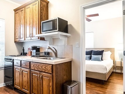 16308 Lake Loop Austin, TX 78734 - Photo 11 of 11 a kitchen with a sink cabinets and a wooden floor