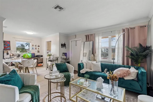 a living room with furniture and a potted plant