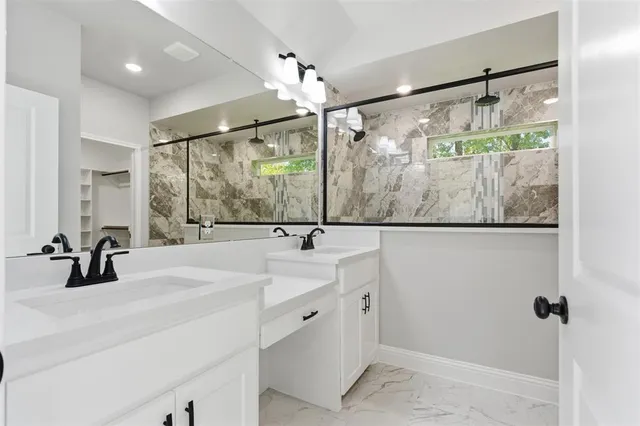 a bathroom with a double vanity sink and mirror