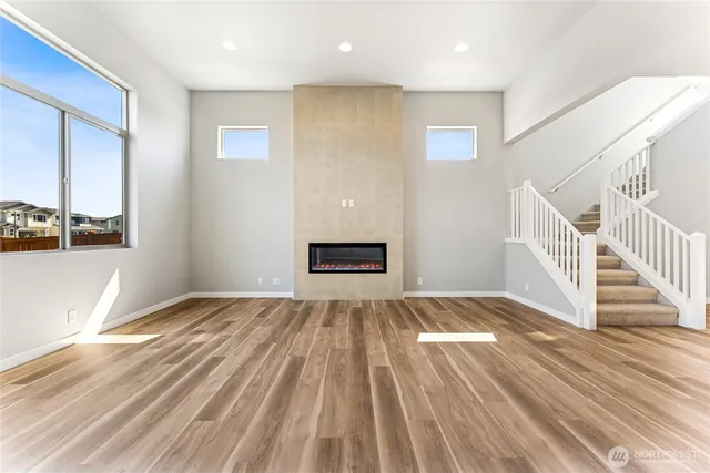 a view of a room with wooden floor and window