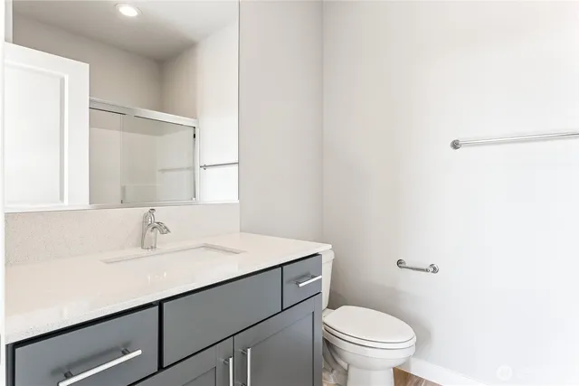 a bathroom with a sink a toilet and mirror