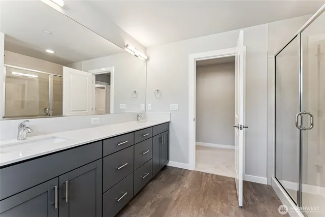 a bathroom with a double vanity sink and mirror