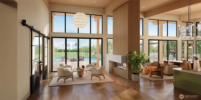 a living room with furniture and floor to ceiling windows