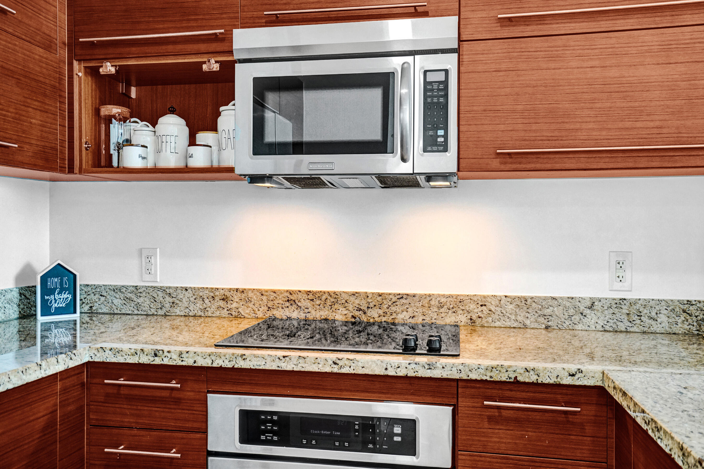 2641 North Flamingo Road, Unit 2105N Sunrise, FL 33323 - Photo 15 of 60 a view of a kitchen with granite countertop white cabinets and black appliances